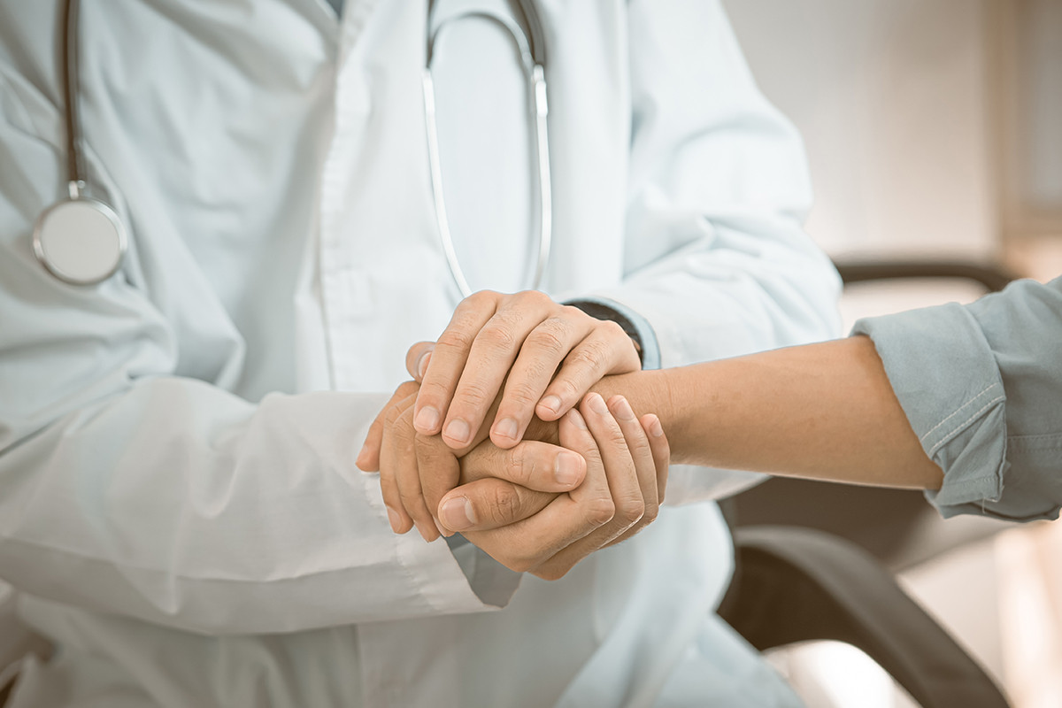 Support, trust and hospital care with a doctor and patient holding hands Support, trust and hospital care with a doctor and patient holding hands
