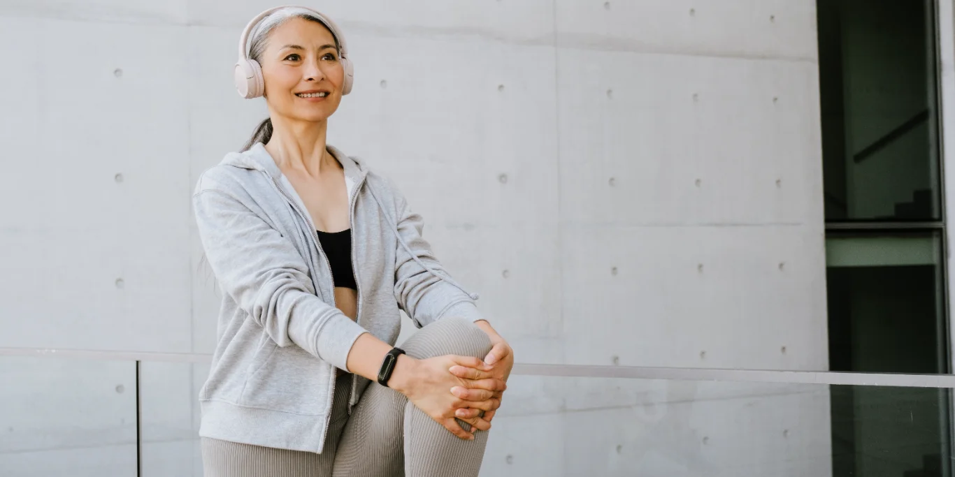 mature woman in headphones doing exercise mature woman in headphones doing exercise